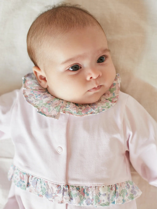 Baby  wearing the Deolinda gardenia babygrow.