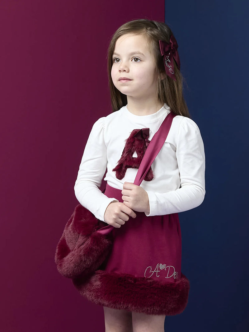 Girl modelling the A Dee alma heart bag.