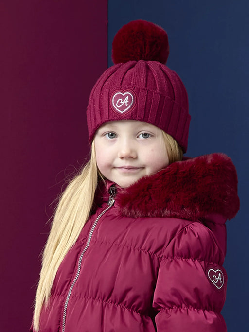 A Dee burgundy bobbie bobble hat, modelled by girl.