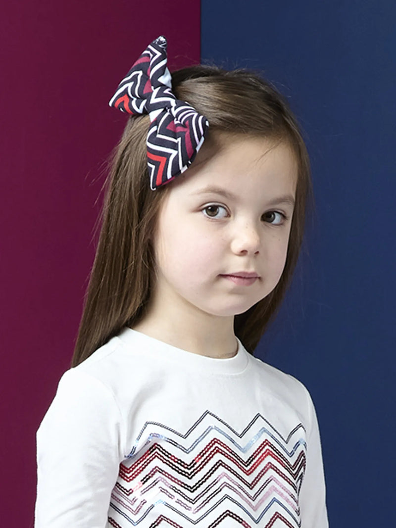 Girl wearing the A Dee brianna bow clip.