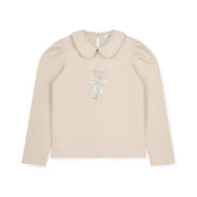 A Dee girl's beige long sleeve top.
