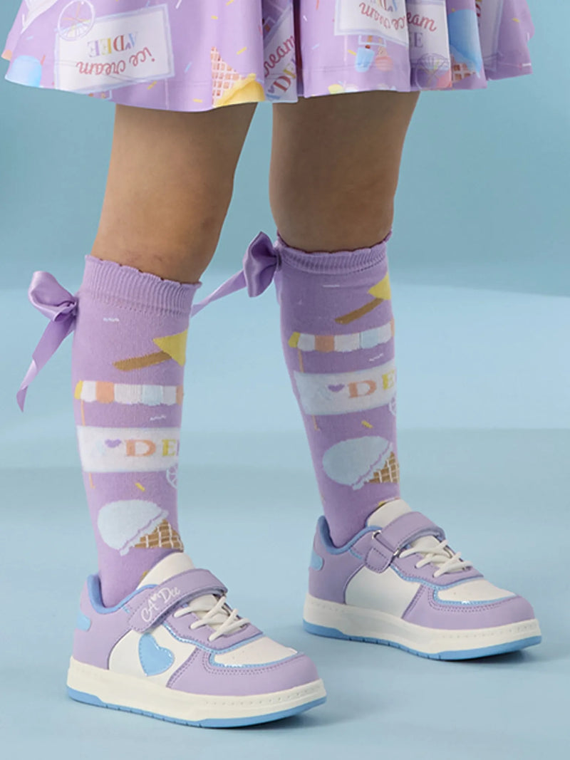 Girl wearing the A Dee dnk trainers.