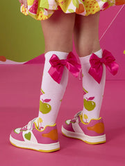 A Dee dnk trainers with green hearts on the side.