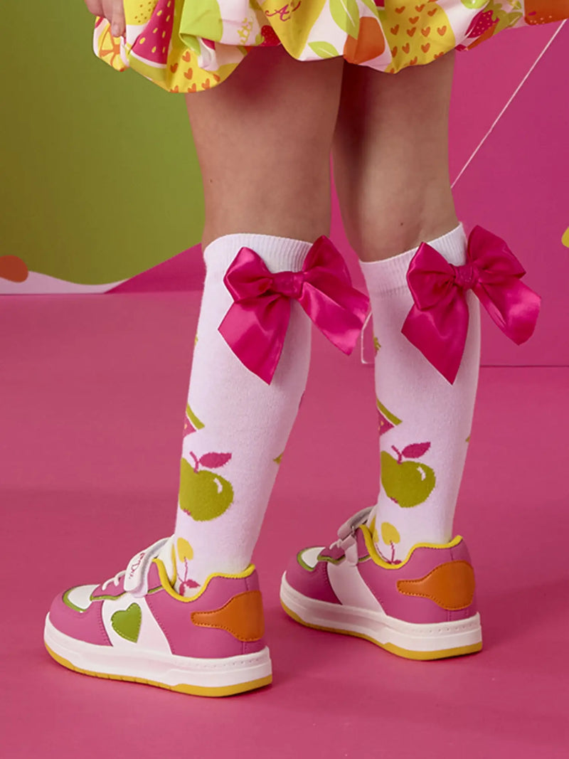 A Dee dnk trainers with green hearts on the side.