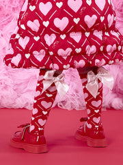 A Dee red socks with pink heart pattern.