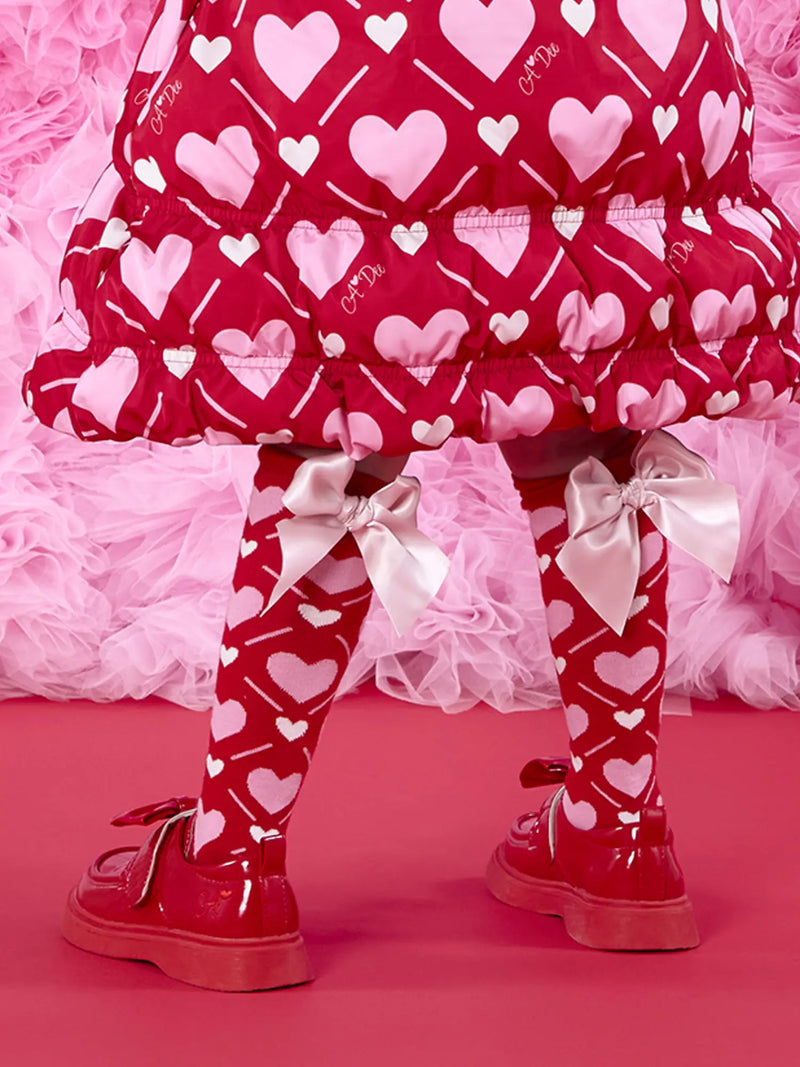 A Dee red socks with pink heart pattern.