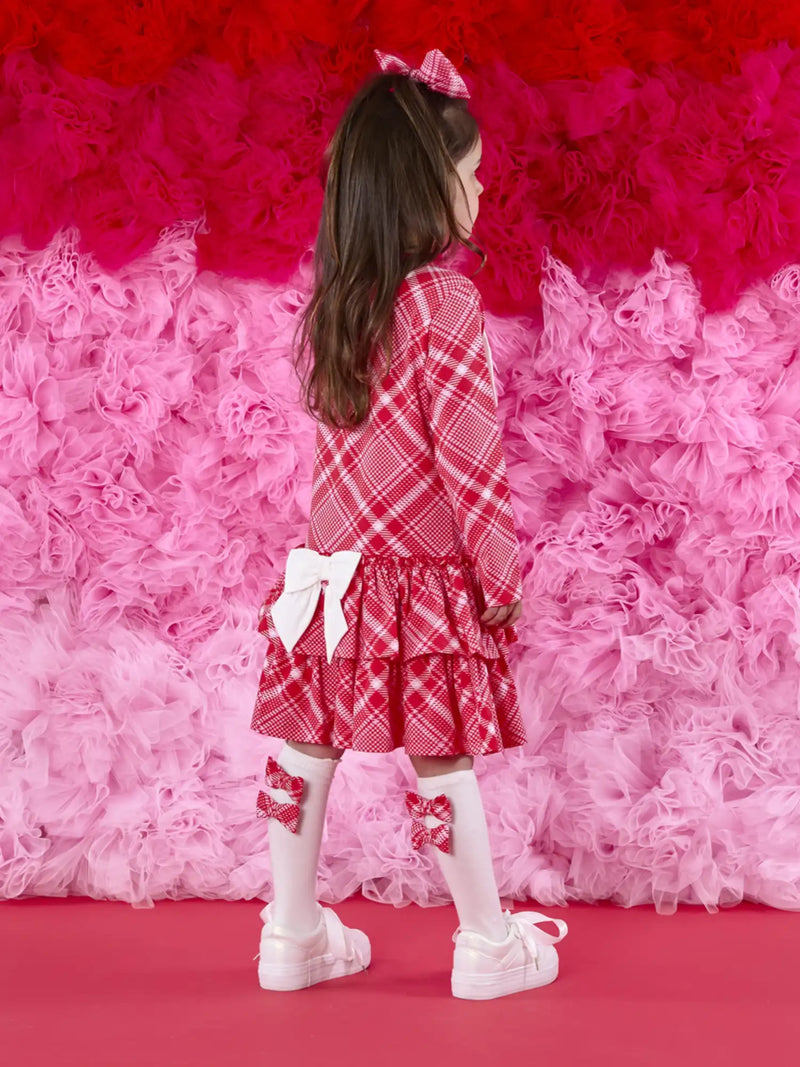 A Dee liberty dress with white bow on the back.