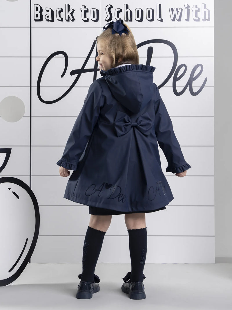 Closer look at the A Dee nova raincoat showing detail of the large bow on the back.