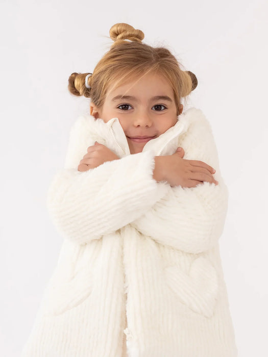 Smiling girl modelling the Agatha Ruiz de la Prada faux fur coat.