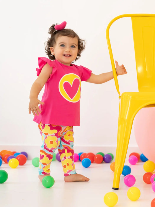 Smiling girl modelling the Agatha Ruiz de la Prada pansy leggings set.