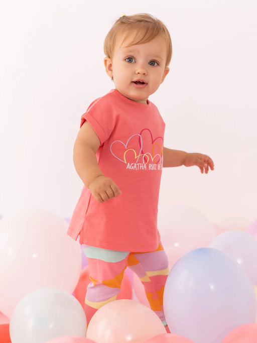 Baby girl modelling the Agatha Ruiz de la Prada lavender leggings set.