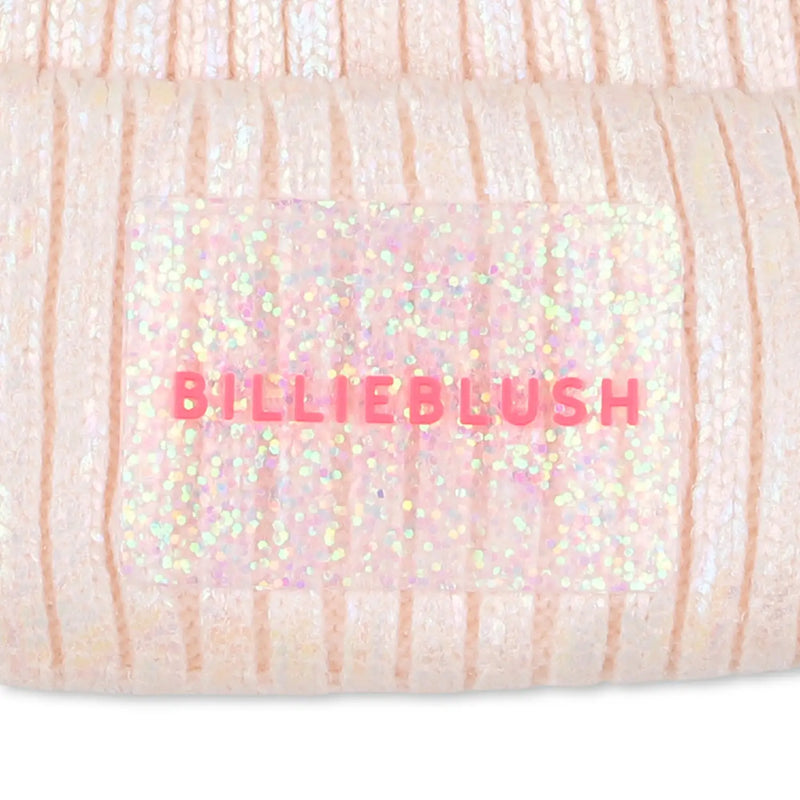 Closer look at the Billieblush bobble hat showing detail of the glitter logo patch