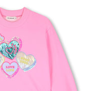 Closer look at the Billieblush combined dress showing detail of the brightly coloured foil hearts.