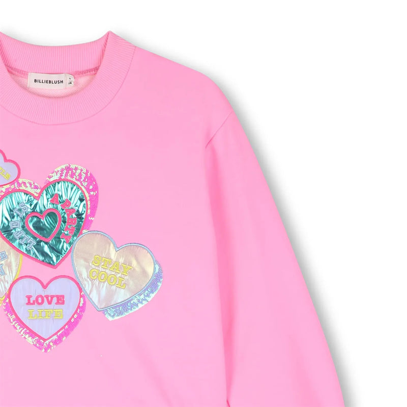 Closer look at the Billieblush combined dress showing detail of the brightly coloured foil hearts.