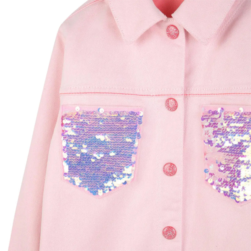 Closer look at the Billieblush denim jacket showing detail of the silver sequin pockets.