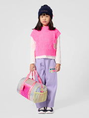 girl modelling the Billieblush gym bag.