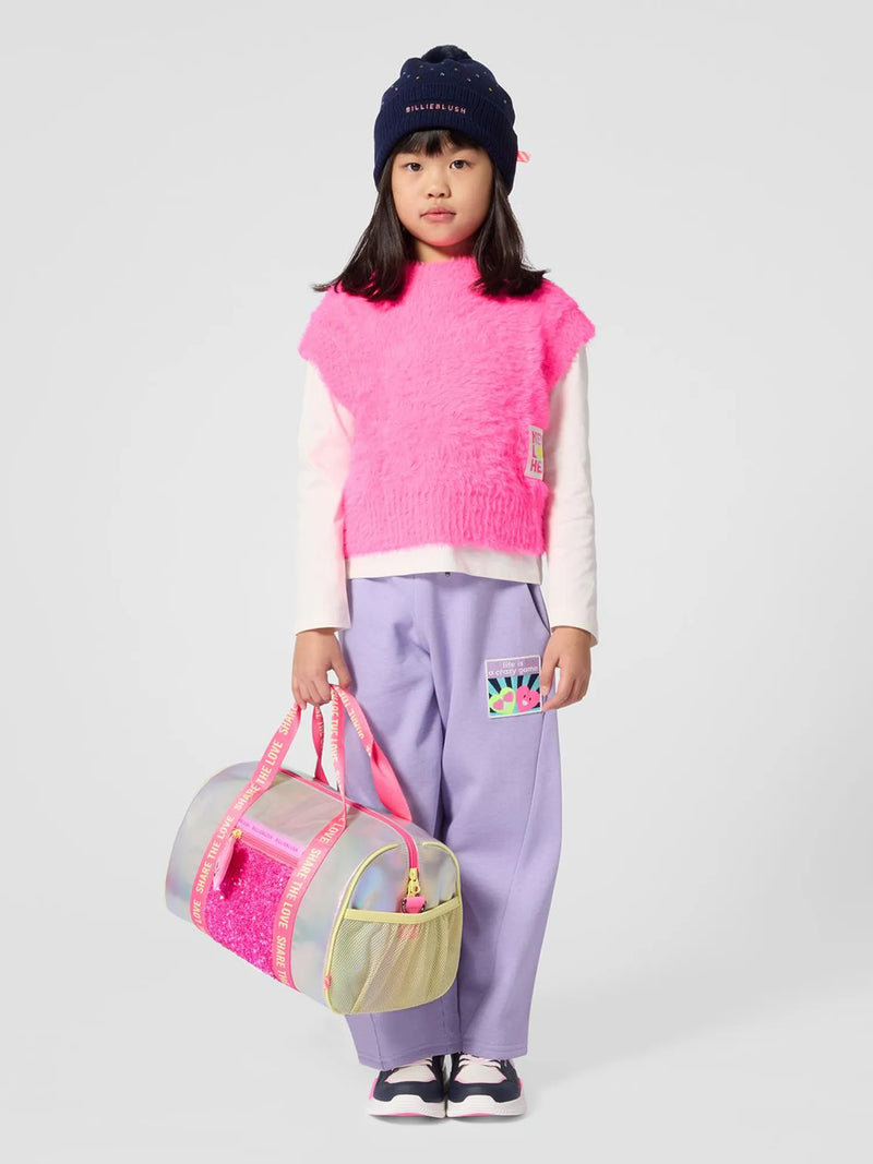 girl modelling the Billieblush gym bag.