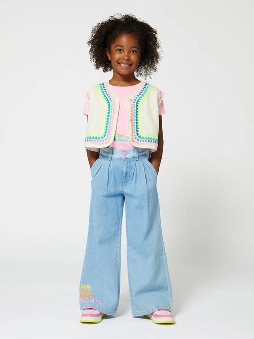 Smiling girl modelling the Billieblush wide leg jeans.