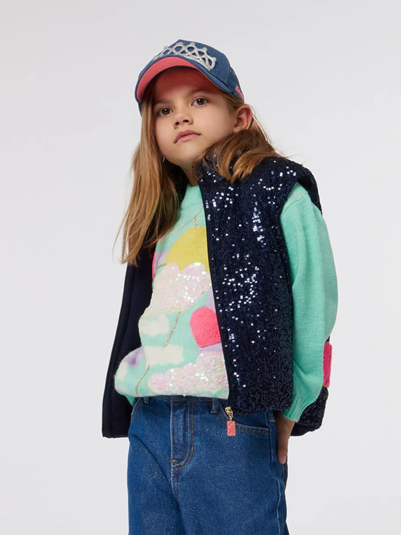 Girl wearing the Billieblush sequin gilet.