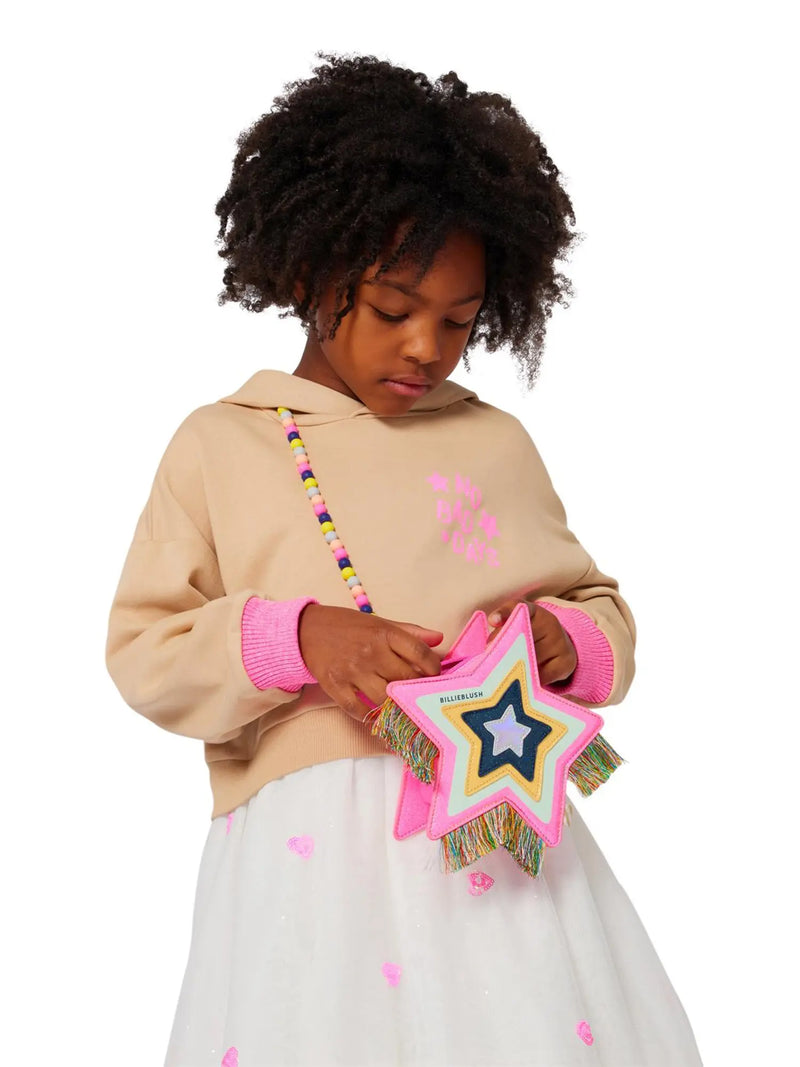 Girl modelling the Billieblush star bag.