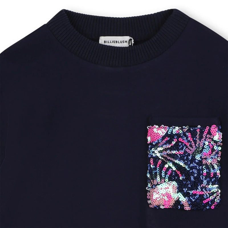 Closer look at the Billieblush sweatshirt dress showing detail of the sequin chest pocket