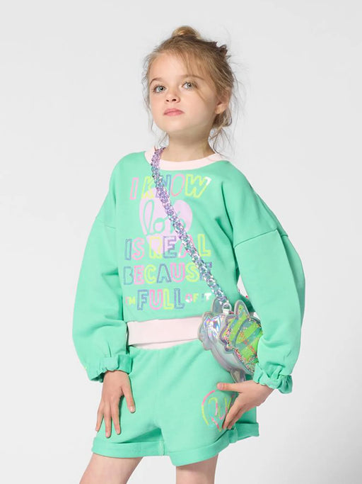 Girl wearing the Billieblush sweatshirt.