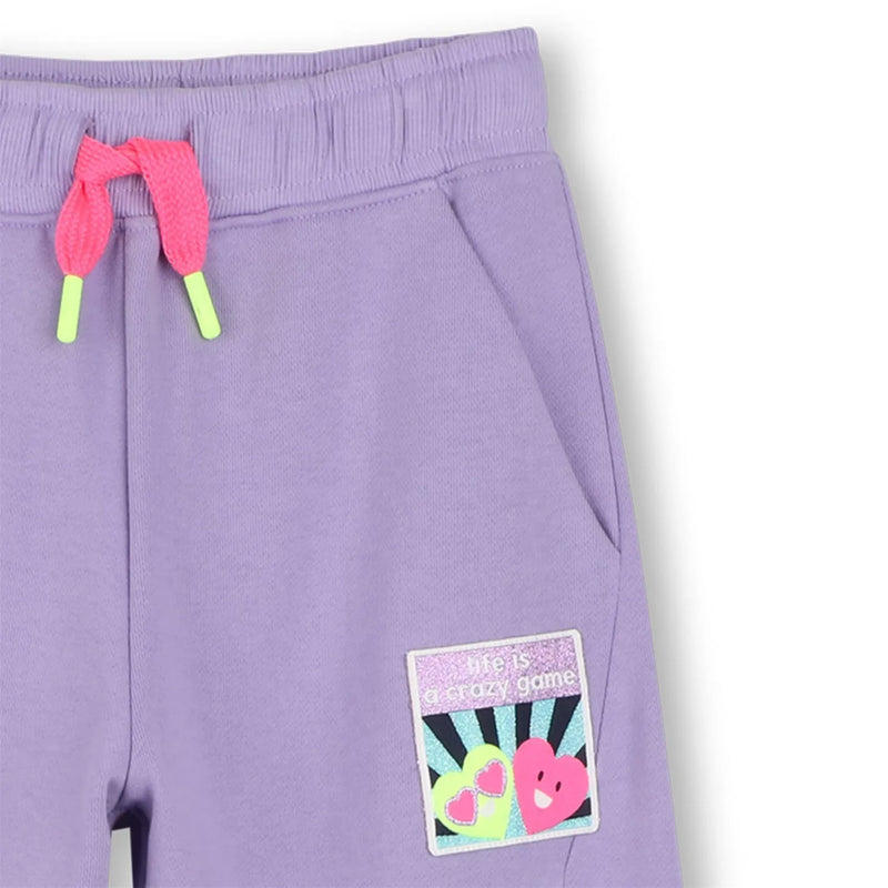 Closer look at the Billieblush track bottoms showing detail of the glitter heart logo.