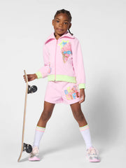 Girl in pink track shorts by Billieblush.