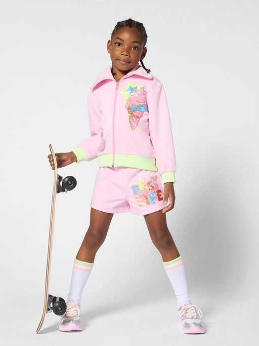 Girl in pink track shorts by Billieblush.