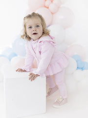 Baby girl in pink maribo tracksuit by Blues Baby.