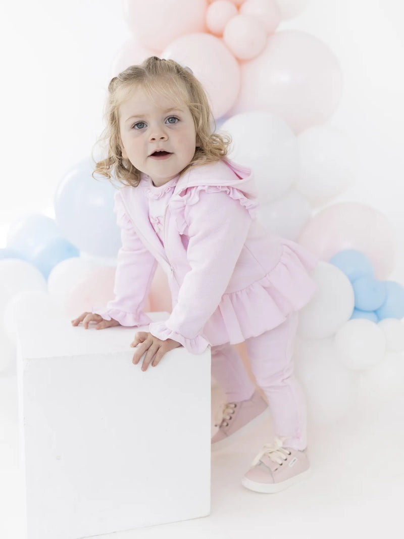 Baby girl in pink maribo tracksuit by Blues Baby.