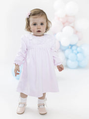 Baby girl modelling the Blues Baby tivoli dress.