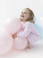 Smiling baby girl modelling the Blues Baby tivoli leggings set.