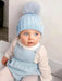 Smiling baby wearing the Bobble Babies pale blue hat. 