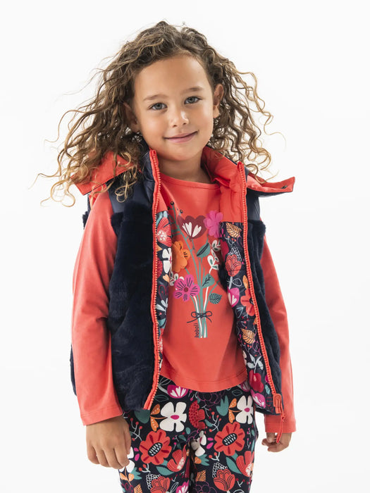 Smiling girl modelling the Boboli reversible gilet.