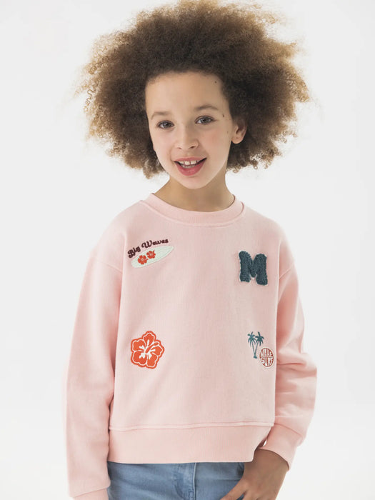 Girl wearing the Boboli sweatshirt.