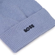 Closer look at the BOSS bobble hat showing detail of the navy embroidered logo.