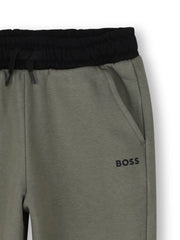 Closer look at the boy's green track bottoms.