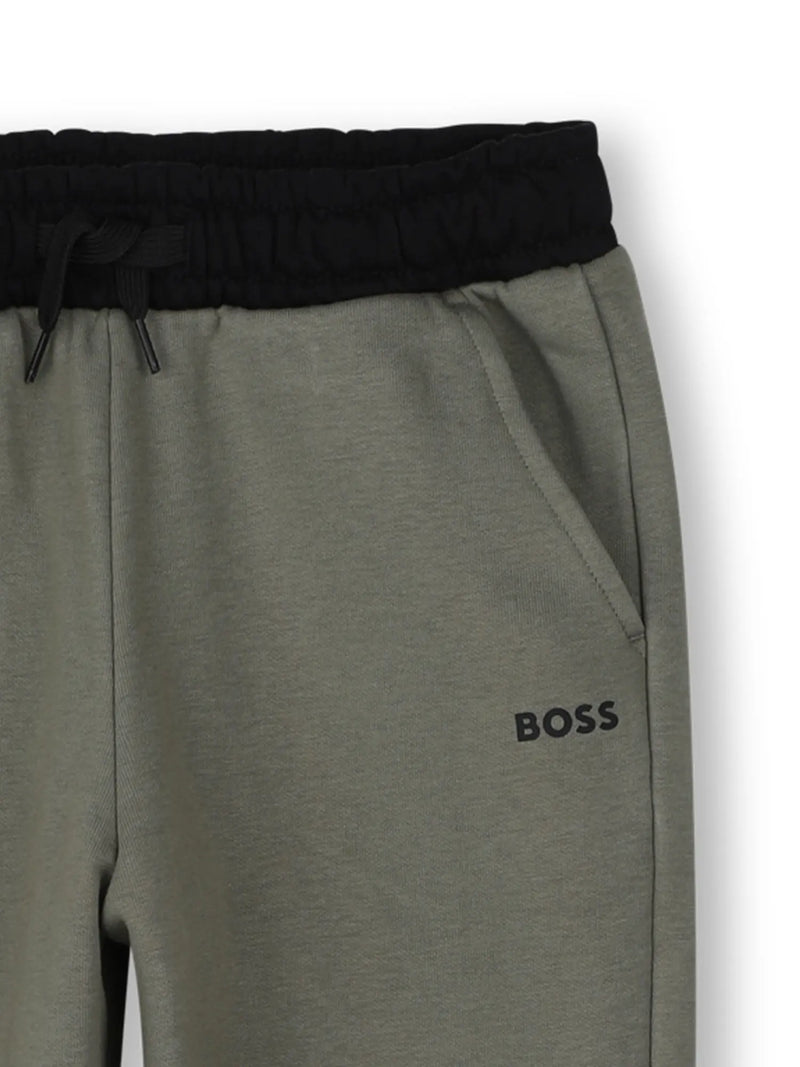 Closer look at the boy's green track bottoms.