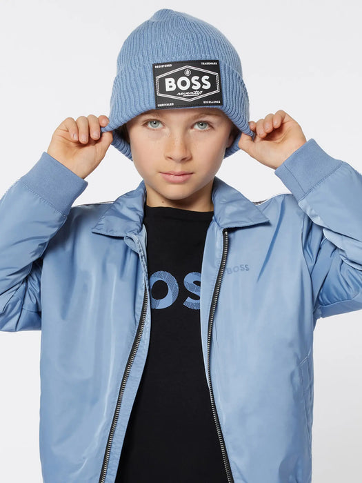 Boy wearing the blue boss logo hat. 