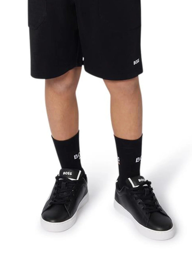 Boy wearing the BOSS socks.