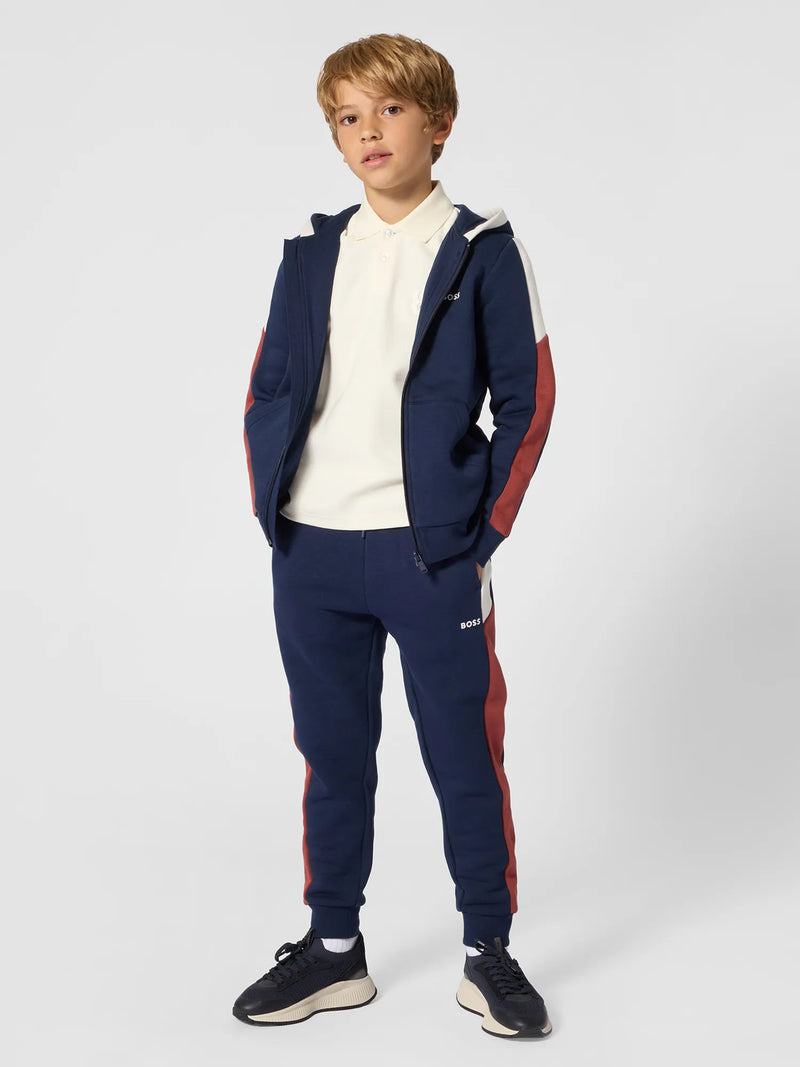 Boy wearing the BOSS track bottoms.