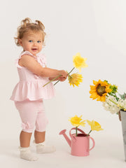 Smiling baby girl modelling the Caramelo bow leggings set.