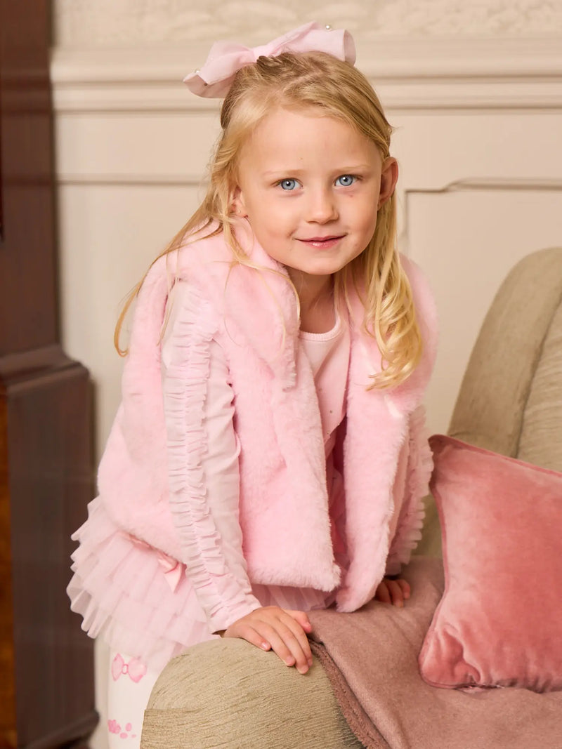 Smiling Girl modelling the Caramelo faux fur gilet.
