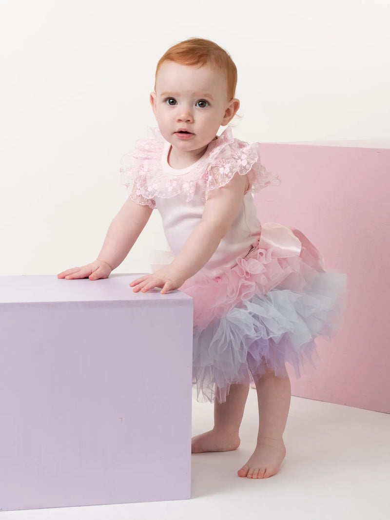 Baby girl wearing the Caramelo rainbow tutu skirt.