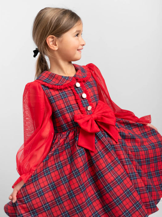 Smiling girl modelling the Caramelo tartan dress.