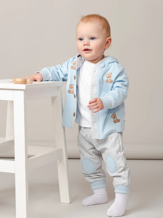 Blue Caramelo tracksuit with embroidered teddy bear pattern.