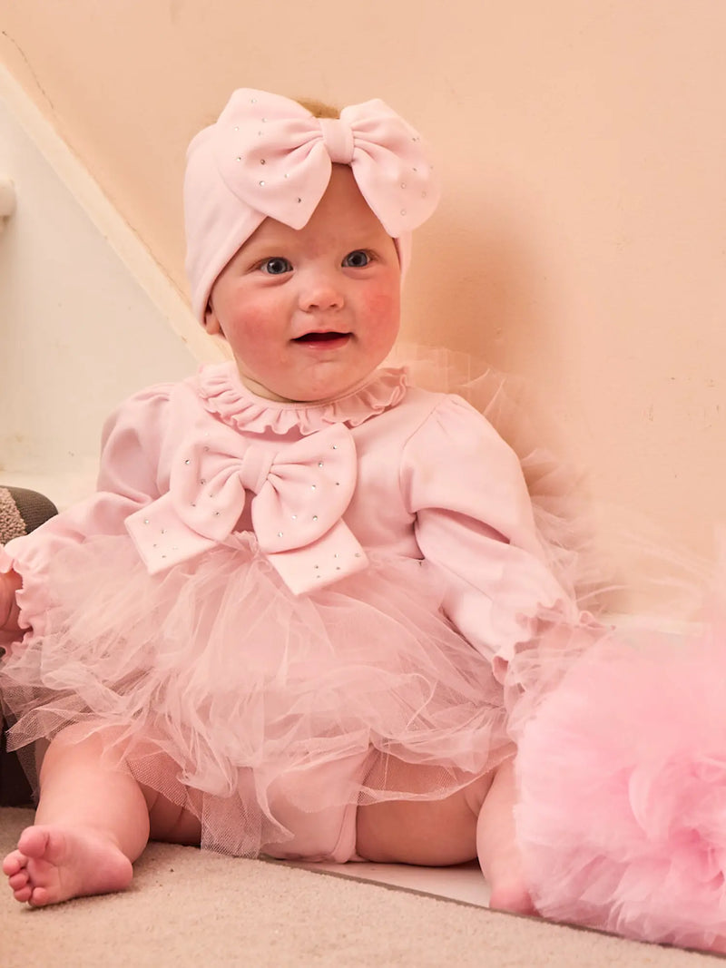 Baby girl wearing the Caramelo tulle dress & headband.