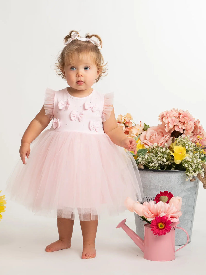 Baby girl modelling the Caramelo tulle dress.