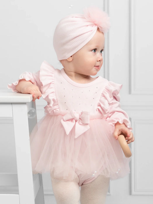 Baby girl wearing the Caramelo tulle dress.